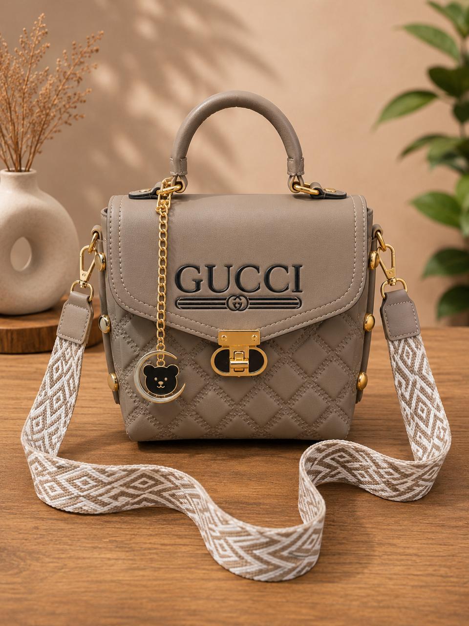 Quilted Chic Crossbody Bag with Decorative Charm & Patterned Strap