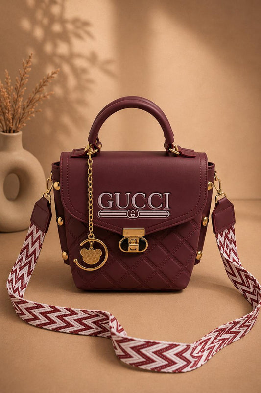Quilted Chic Crossbody Bag with Decorative Charm & Patterned Strap